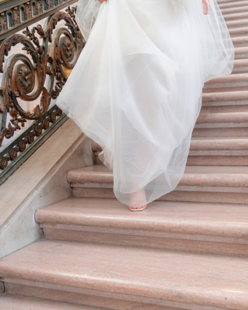 walking down city hall staircase in wedding dress