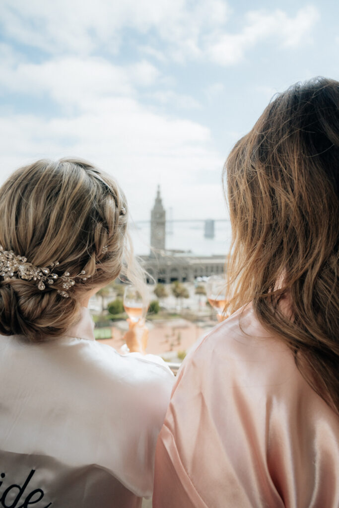 Bride and Bridesmaid gaze at Ferry Building View in San Francisco
