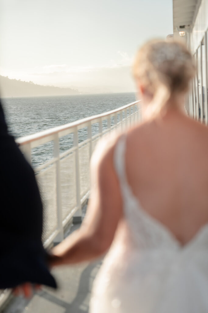 Bride and Groom on boat at sunset