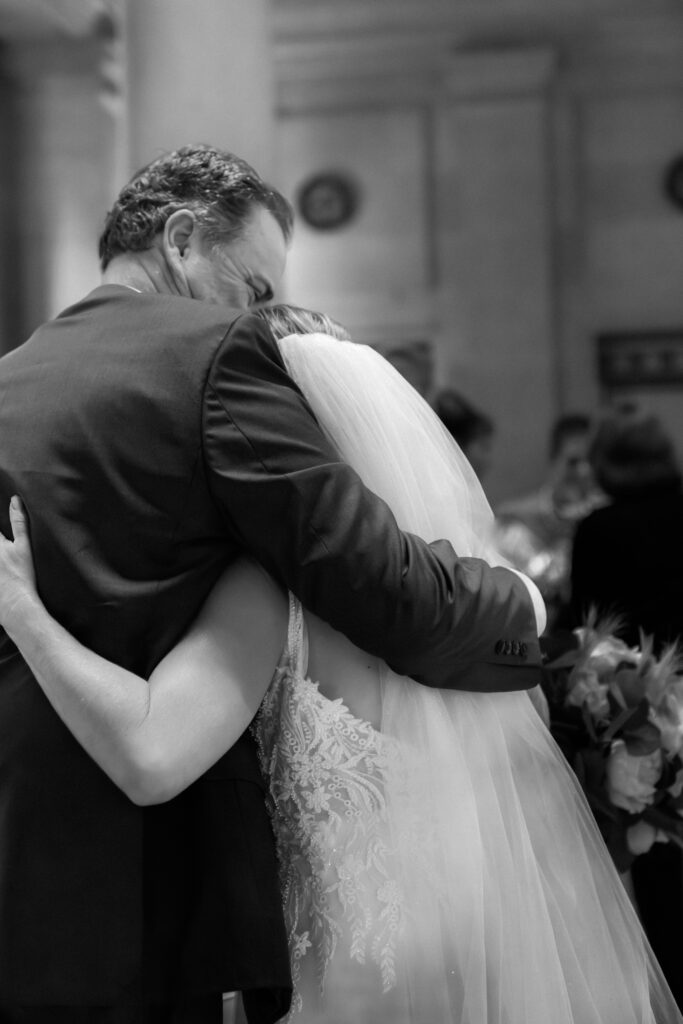 Bride hugging her father after ceremony