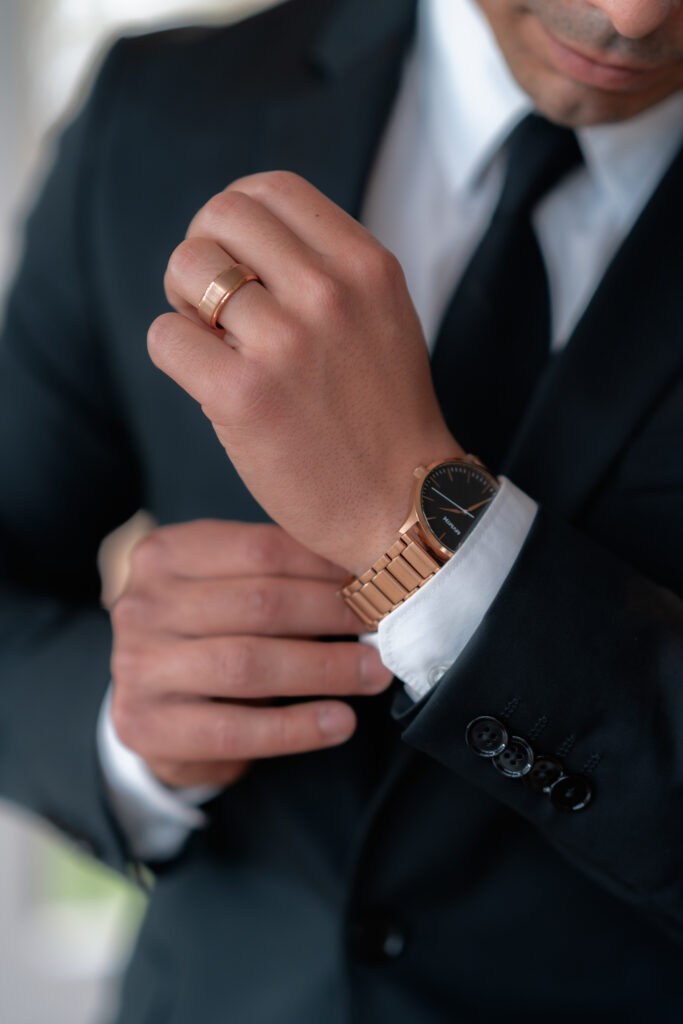 California Groom fixes cuff link on wedding day