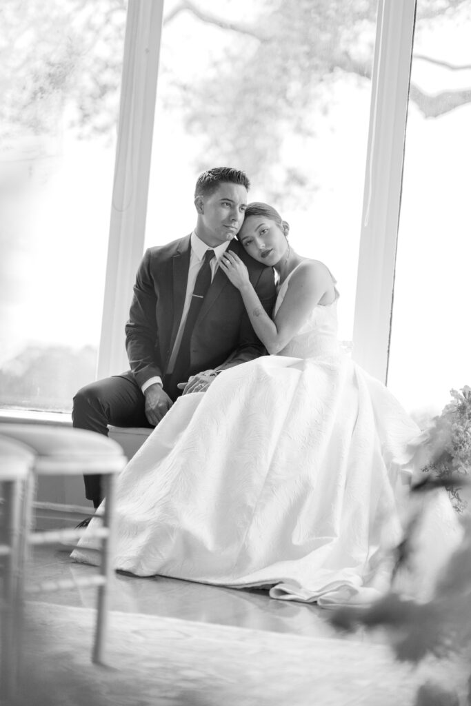 California wedding couple sit together by window