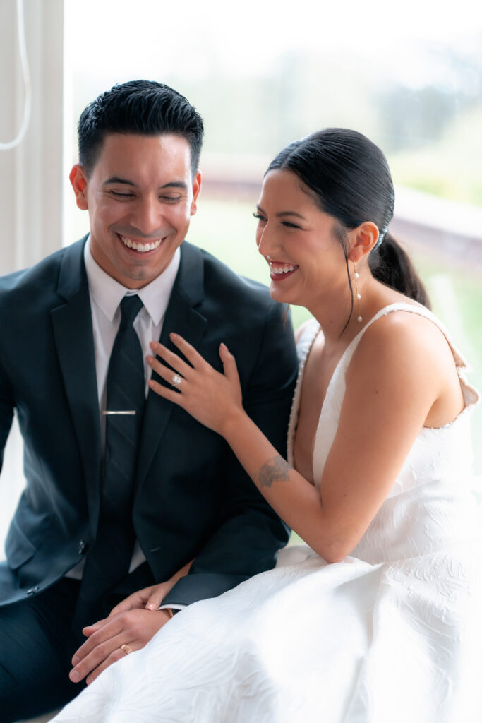 Candid photo of wedding couple laughing together