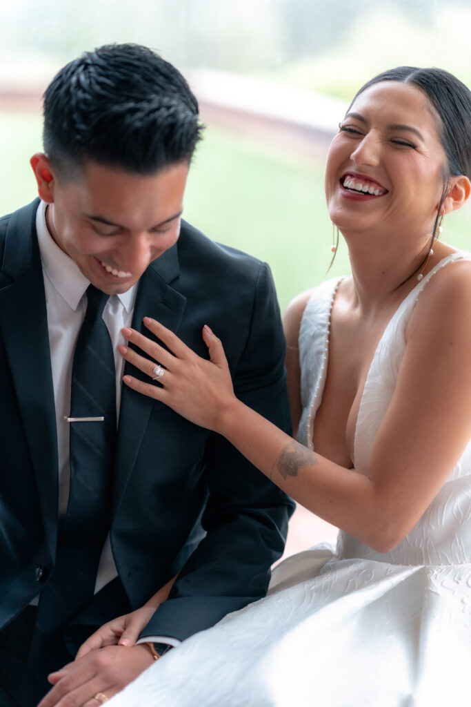 Candid photo of wedding couple laughing together