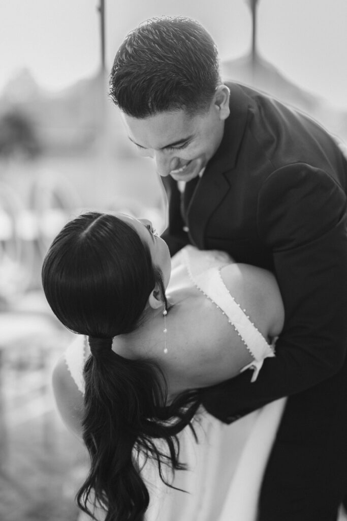 Groom dipping his bride at ceremony