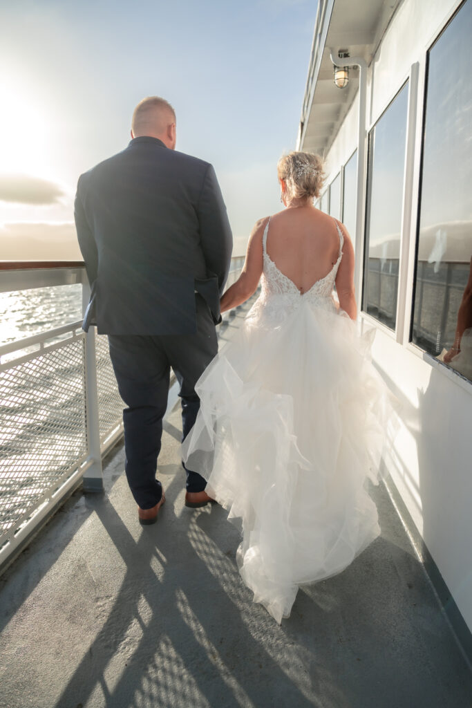 sunset cruise wedding reception walking into the sunset on boat