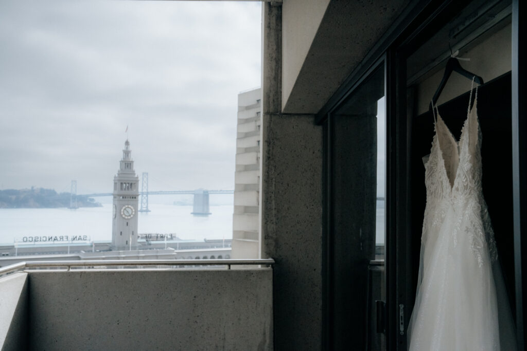 wedding dress details with view of ferry building in san francisco