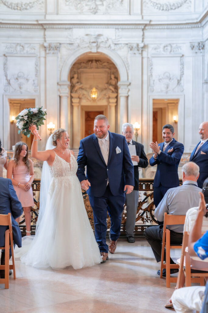 kiss and tell wedding ceremony at city hall down the aisle